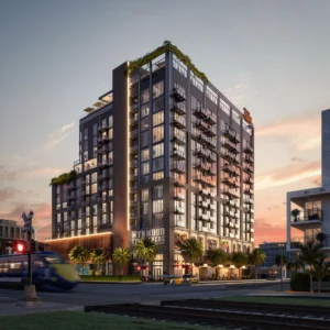 Fachada iluminada de The Ryder at Wynwood al atardecer, con diseño moderno y detalles artísticos.